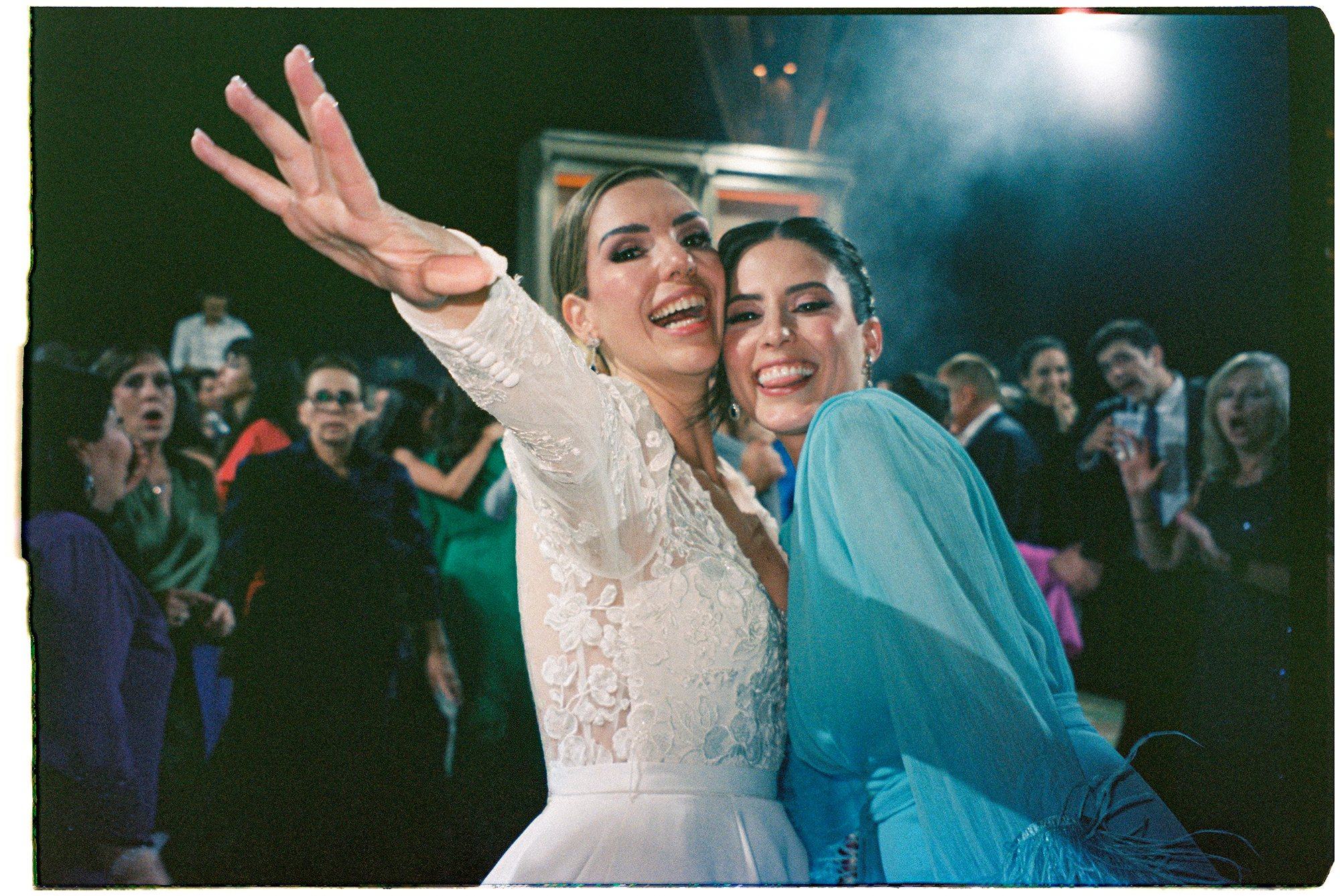 Bride laughing with a guest on the dance floor, direct flash on 35mm film — David Lack